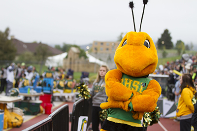 Sting poses for a photo at a home football game.