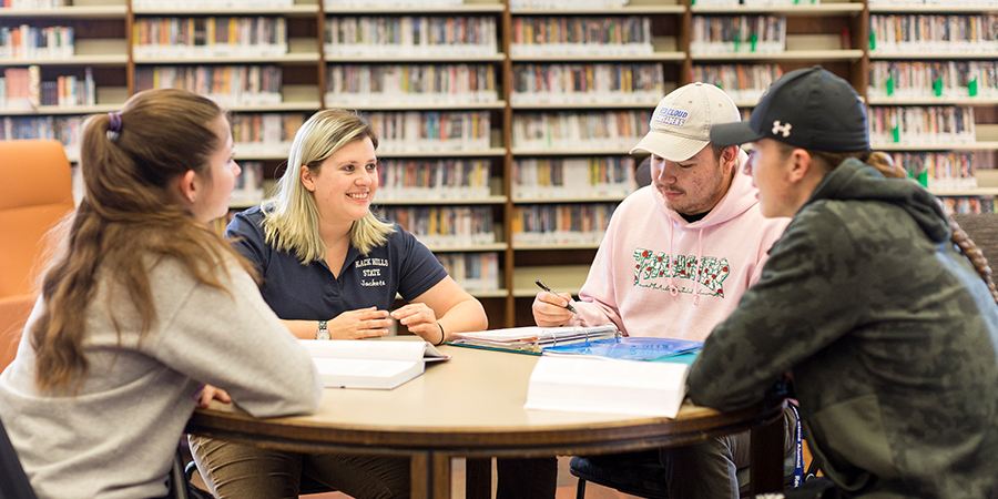 Four students study at a table. 