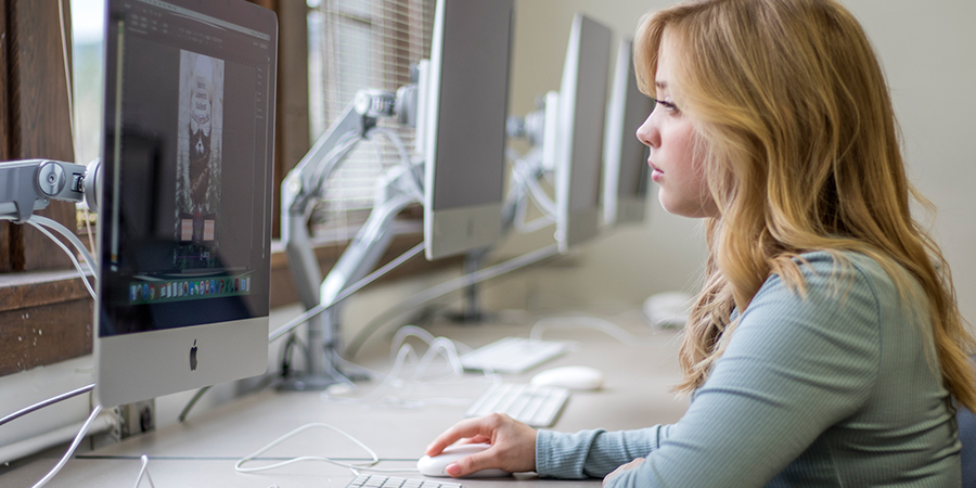 Woman edits photograph on a computer.