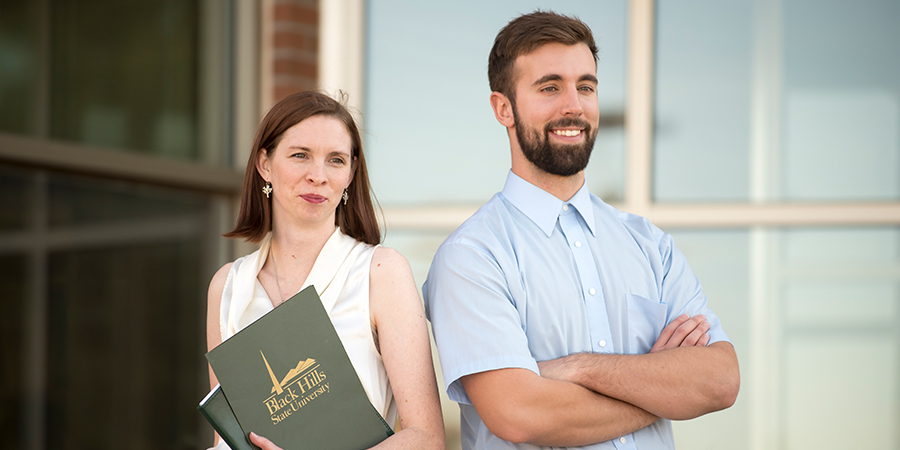 A woman and a man pose for the camera. 