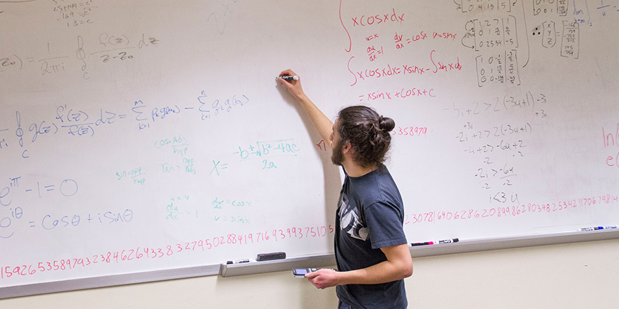 Man writes on a whiteboard.