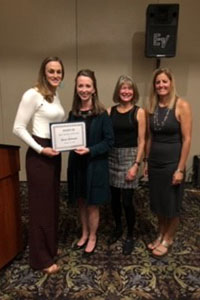 Four BHSU alumni accepting an award