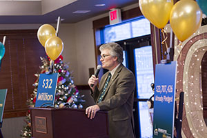 Picture of man making a speech behind a podium