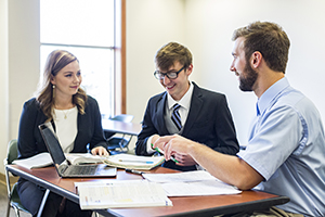 Three BHSU students working on homework together