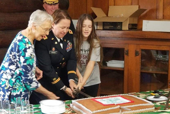 Stacy Goodman and family cutting cake together
