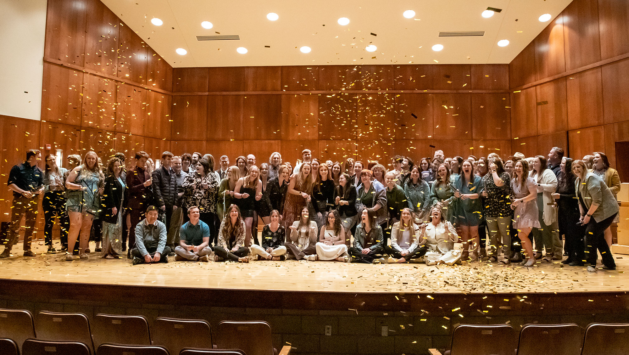 students celebrating onstage at the student volunteer awards