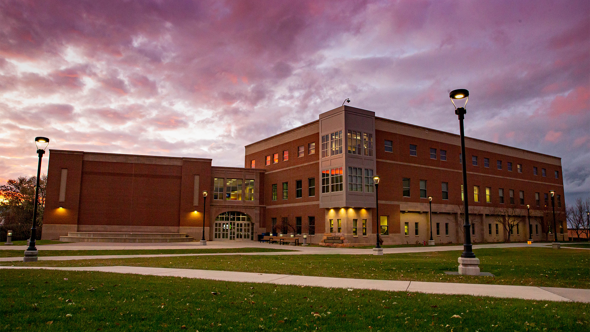 Meier Hall sits in the foreground before an evening sky.