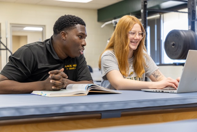 Exercise Science students studying together in the lab, reviewing research materials and collaborating on coursework