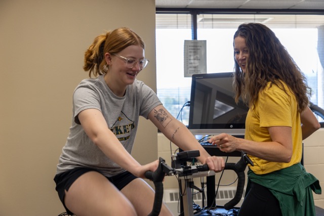 Student cyclist receiving a fitness assessment from an instructor in the BHSU Exercise Science lab, demonstrating hands-on learning opportunities available through the program.