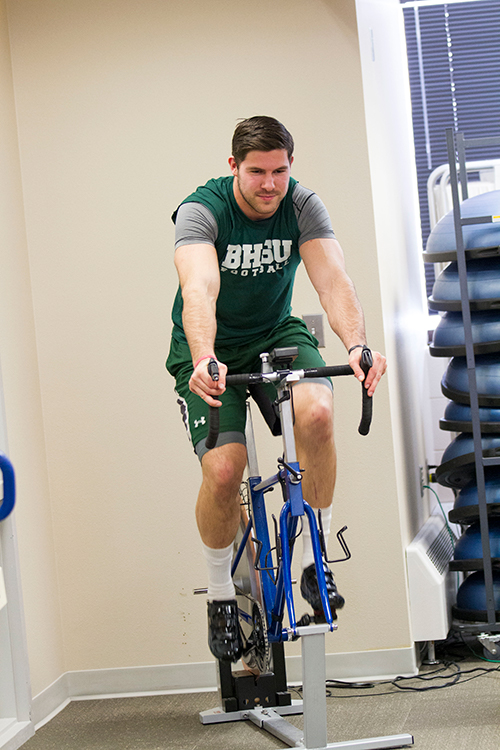 Student riding the Velotron Cycle Ergometer