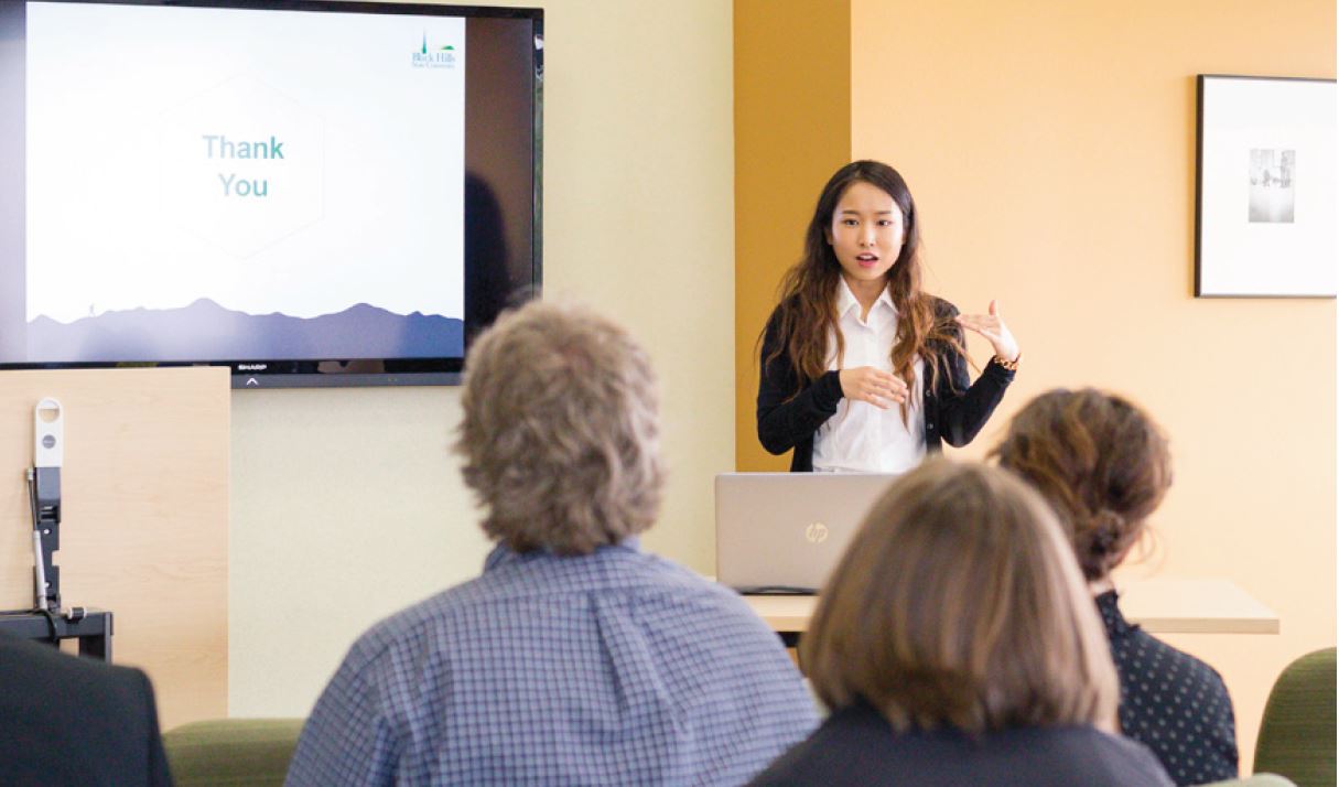 Student presents research to an audience. 