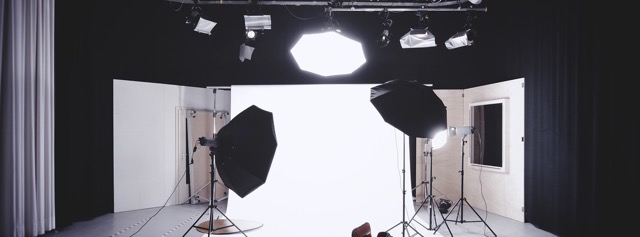 Photography stage with lights spotlighting the center wall