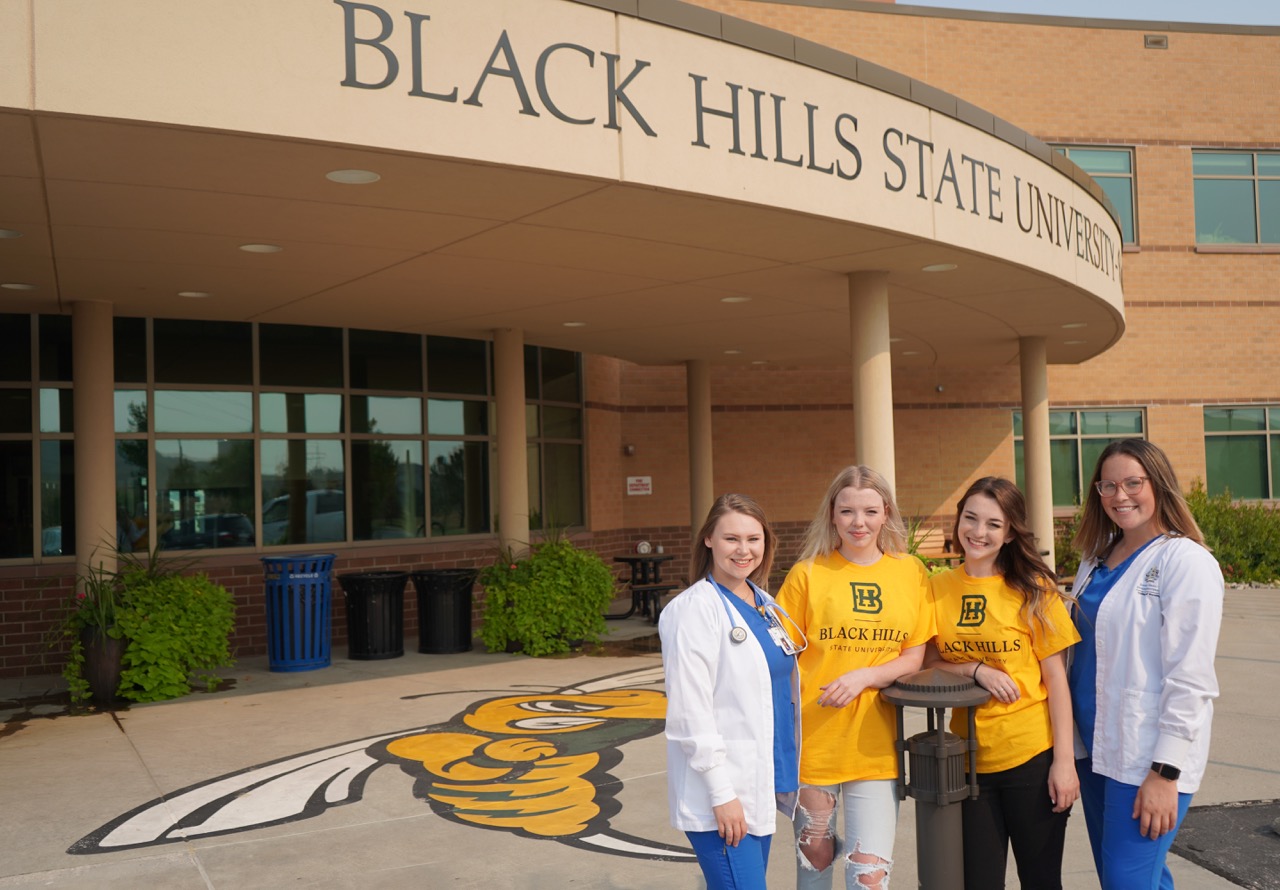 Four female nursing students standing outside of BHSU university center.