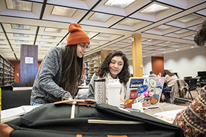 Two BHSU students working together on homework in the library