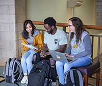 Three students sitting and studying together in Meier Hall
