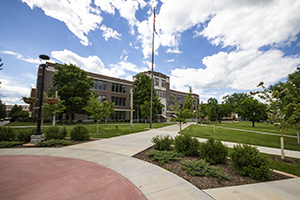 Picture of Woodburn hall, trees and landscape, blue cloudy sky in the background