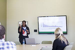 BHSU student doing a business presentation for two other people