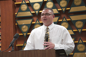 Jhett Albers speaking behind a podium