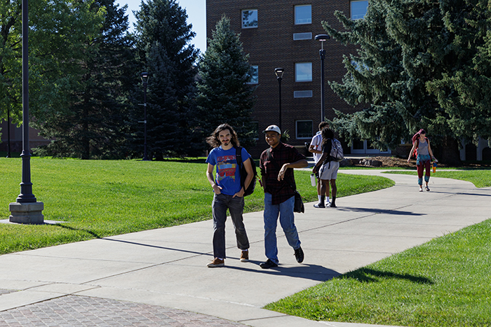 students walking on campus green