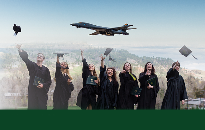 graduates throwing their caps into the air with a plane flying behind them