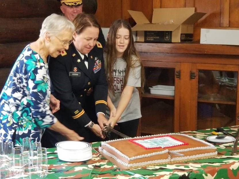 Stacy Goodman and family cutting cake together