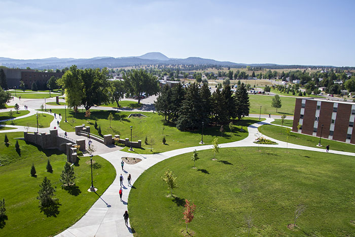 Students walking outside of the peaks