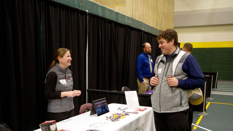 Image of student speaking with employer at the BHSU Teacher Fair