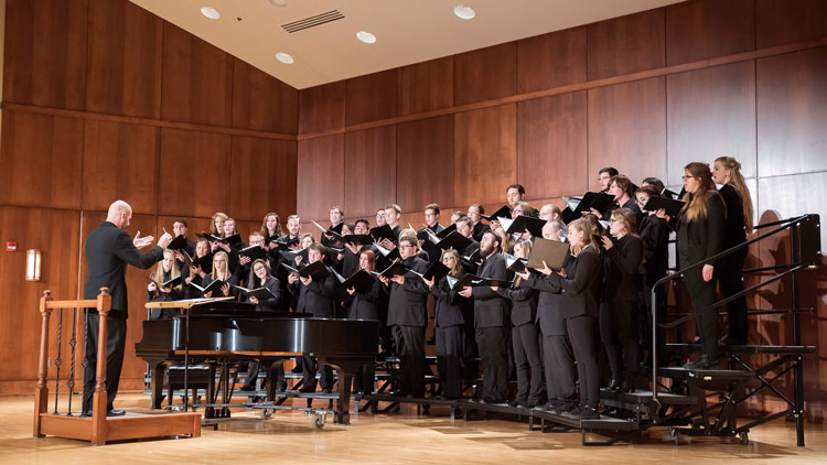 Picture of the BHSU Choir performing on stage in the Meier Hall Auditorium