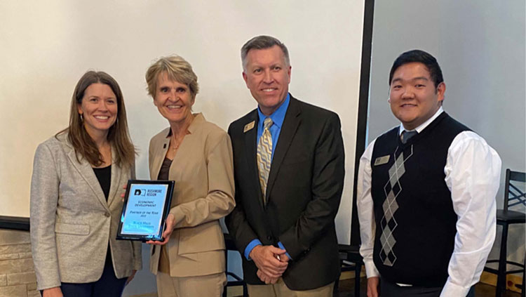 Fran White (left), executive director of BHCED, presents the Rushmore Region Partner of the Year award to BHSU President Laurie S. Nichols, r. Jon Kilpinen, provost and vice president for Academic Affairs, and Jin Kim, director of Career Development at the annual Small Business RoundUP event hosted by Black Hills Community Economic Development. 