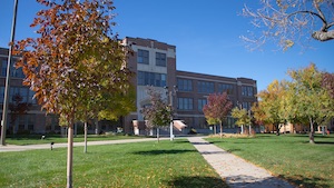 Fallen leaves scatter the ground in front of Woodburn Hall.