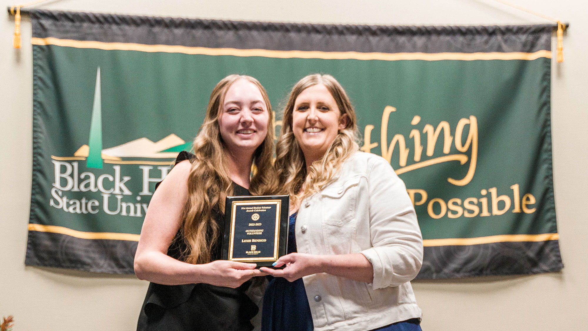 BHSU female student accepts awards from Jessie Gramm
