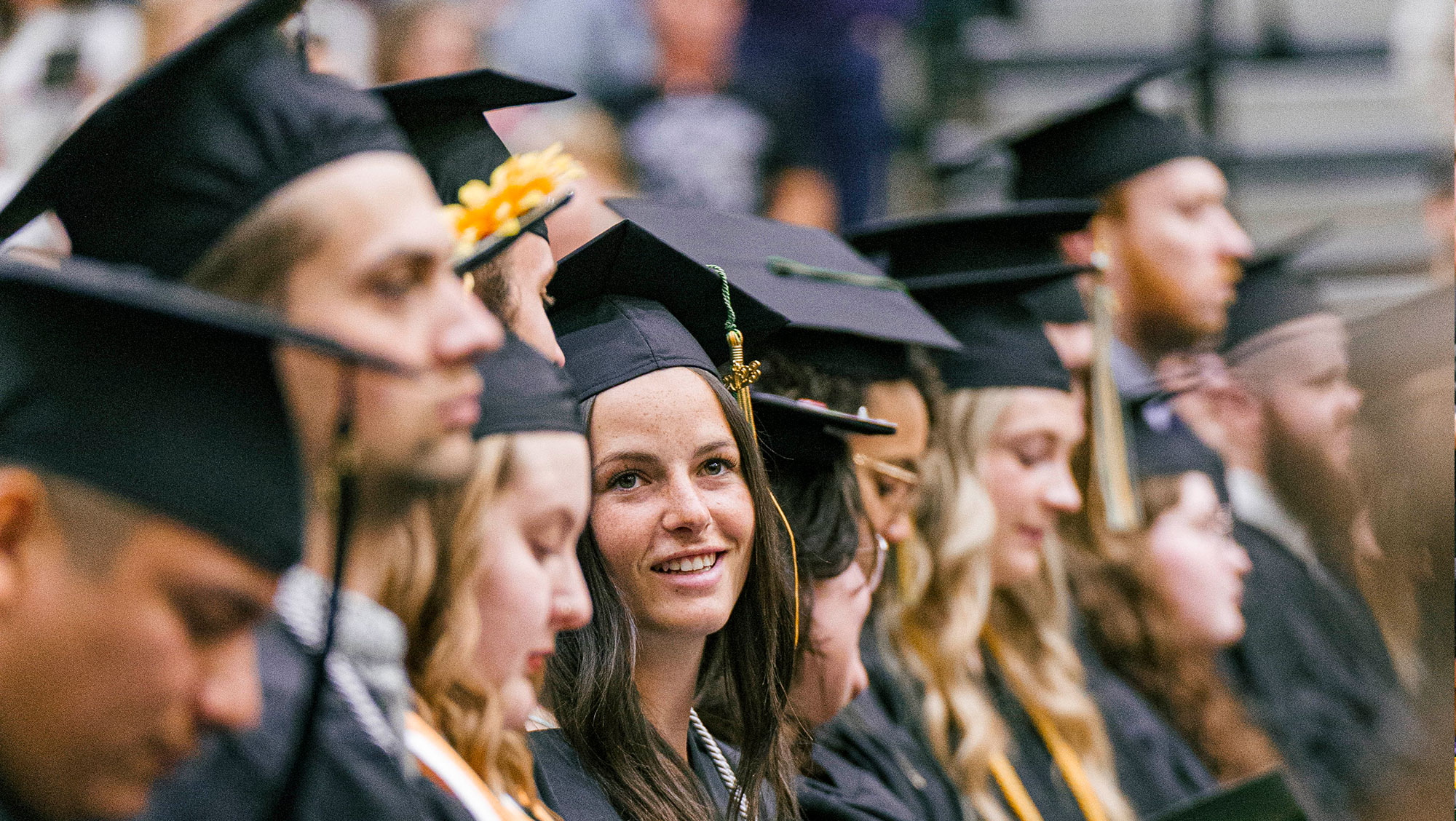 Image of BH students standing in a row with graduation caps on at Spring 2023 Commencement.