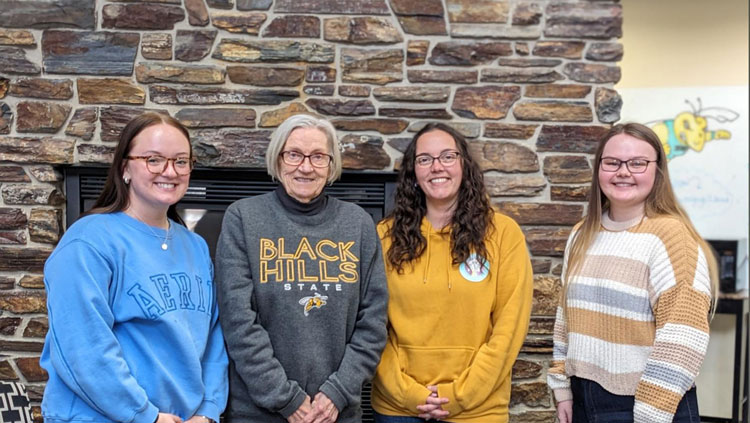 Black Hills State University students meet with the donor of their scholarships, Carol Lundberg. Lundberg recently increased her scholarship, adding three new recipients this spring. Standing (left to right) are Hadley Marquardt, Carol Lundberg, Marissa Tuttle, and Katie Pedneau.