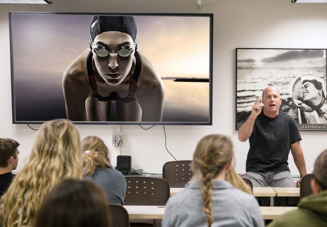 A man lectures BHSU photography students in a classroom.