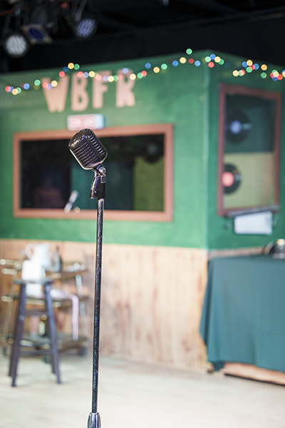 old fashioned radio microphone against a green background