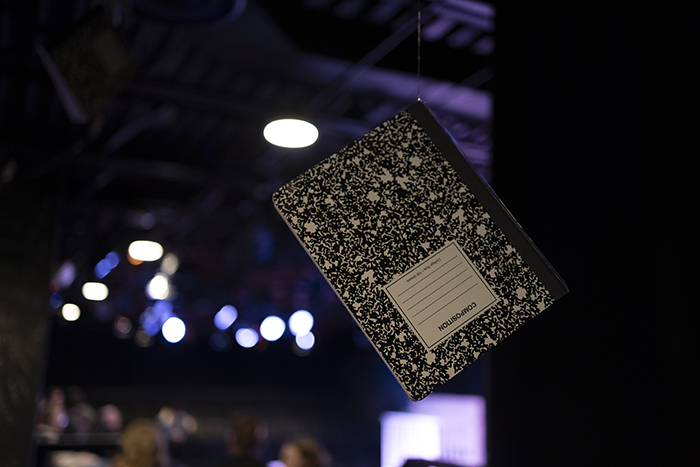 A composition style notebook hanging from the ceiling