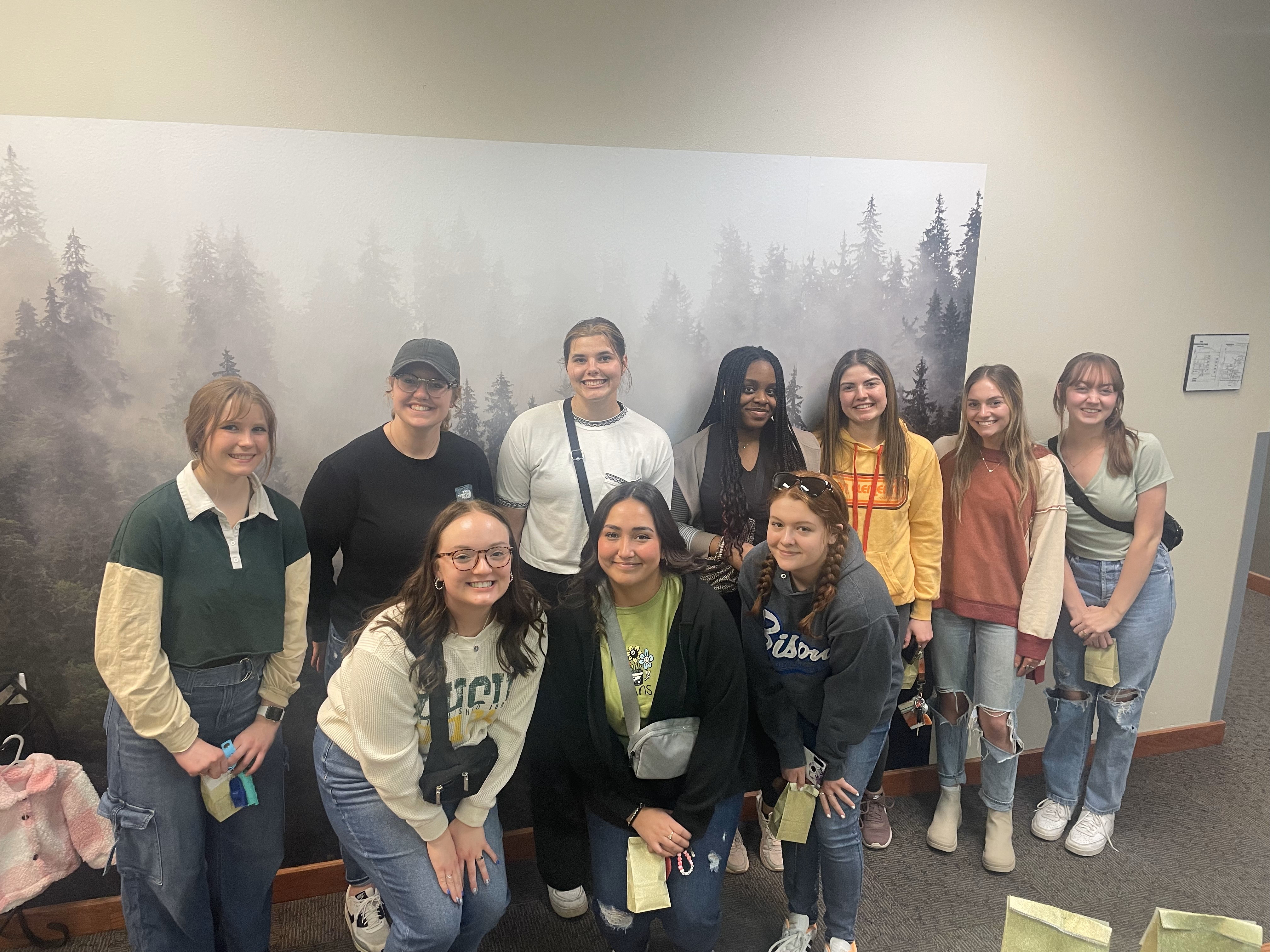 Ten psychology club members pose for a photo while volunteering with NHTC.