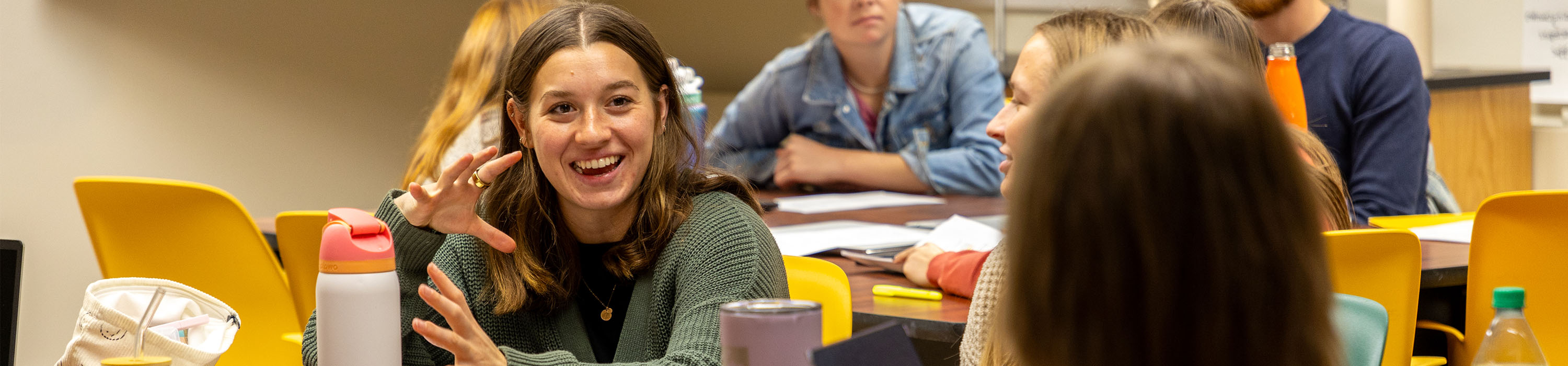 A MAT Special Education student sits with a group of other students having a discussion.