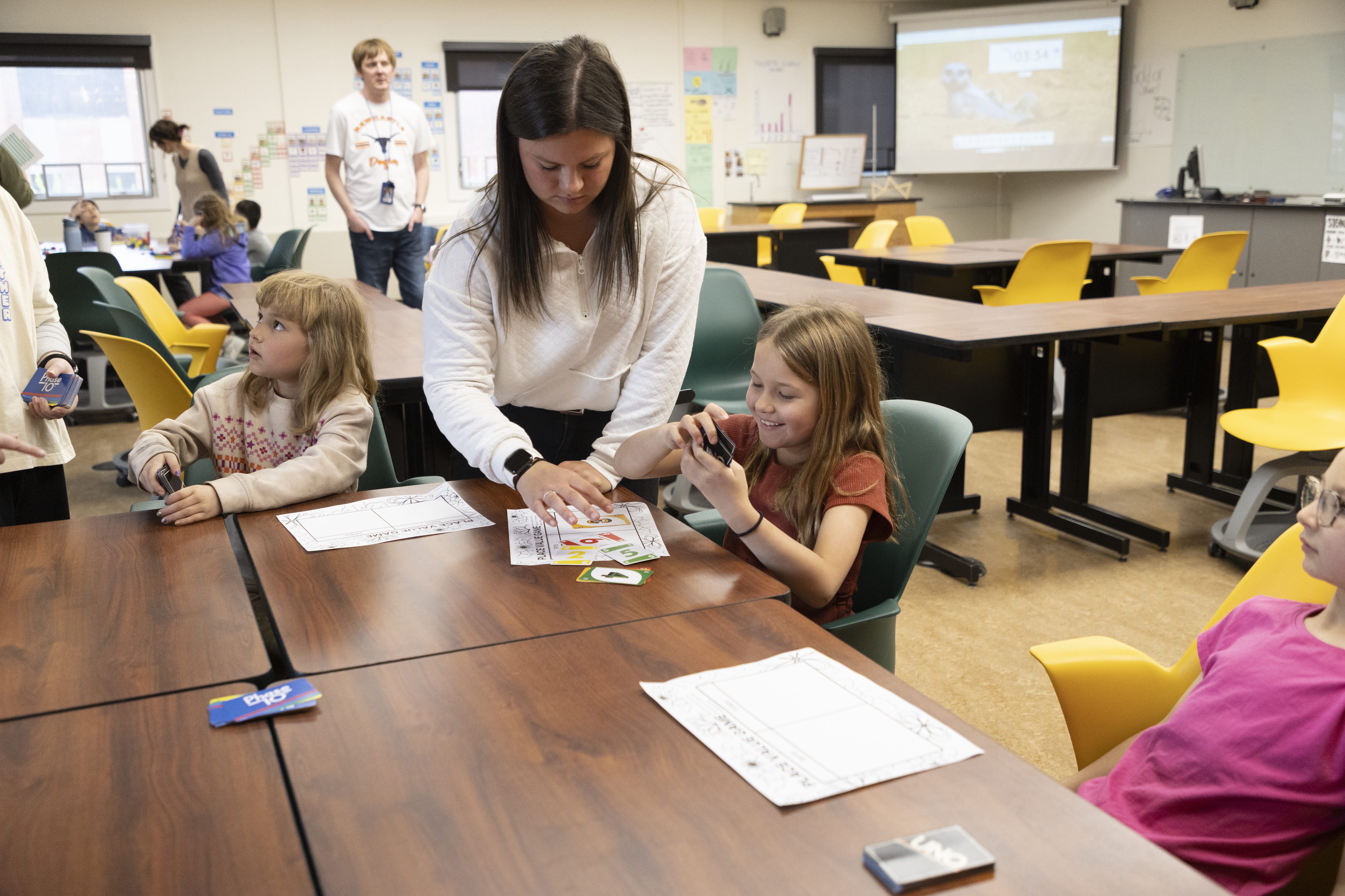 An Elementary Education student works with children at an on-campus event.