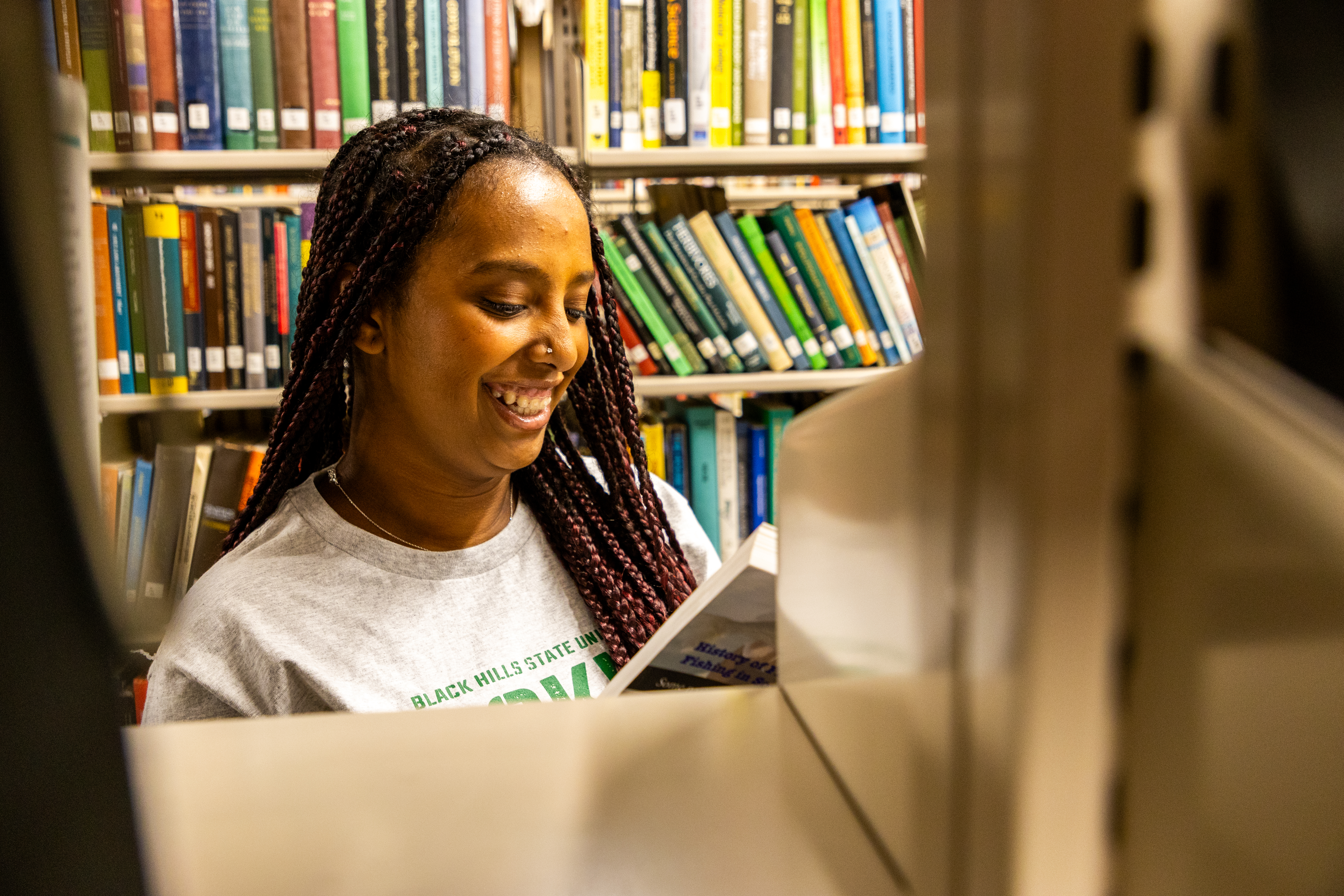 A BHSU student reading in the library