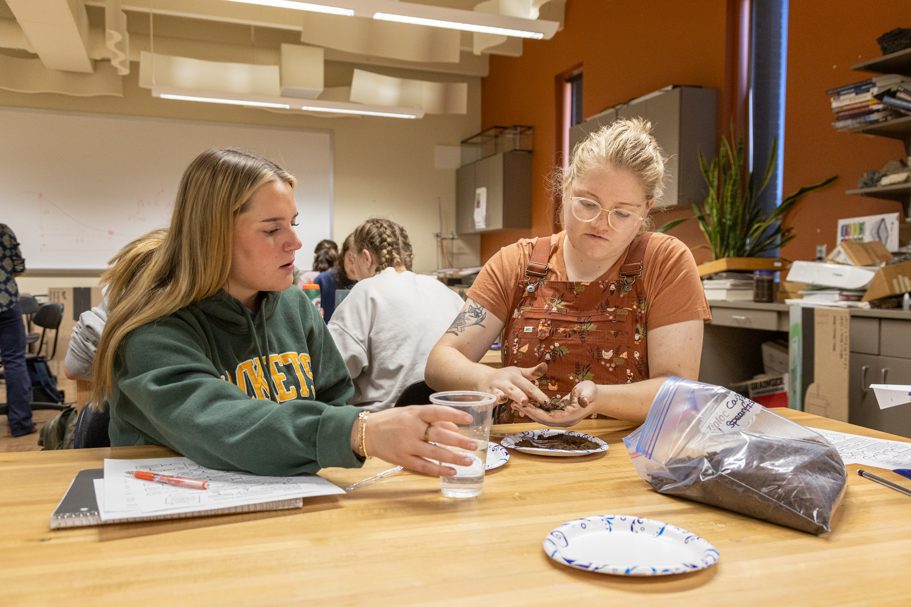 Two female geology students work together on a lab.