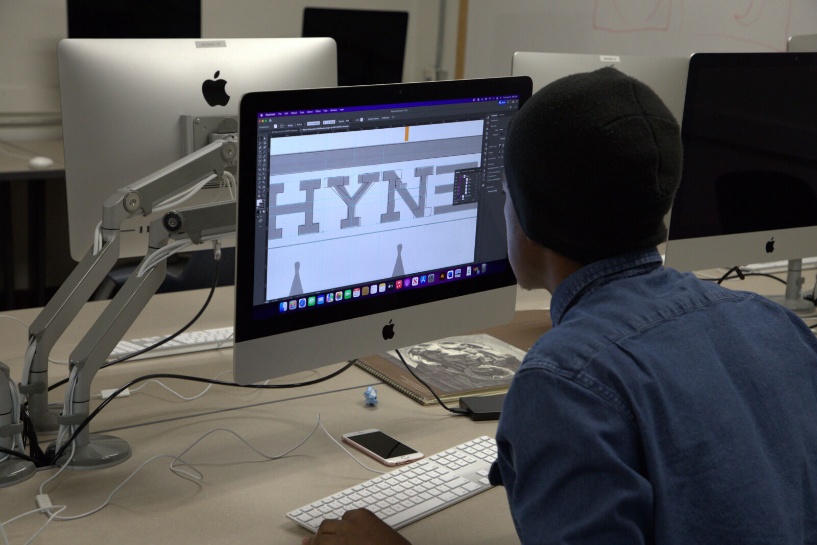 A BHSU student uses PhotoShop on a Macbook.