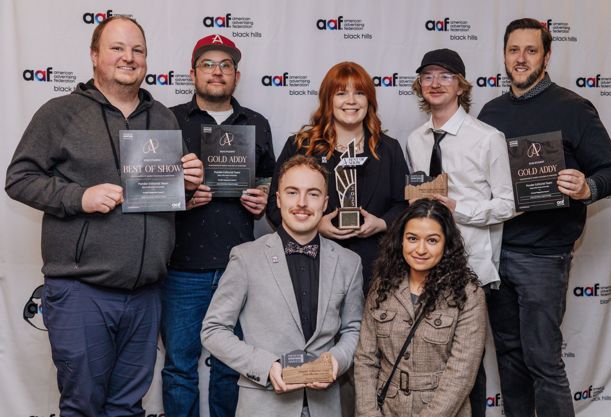 Members of student magazie, Ponder, pose for a photo with awards.