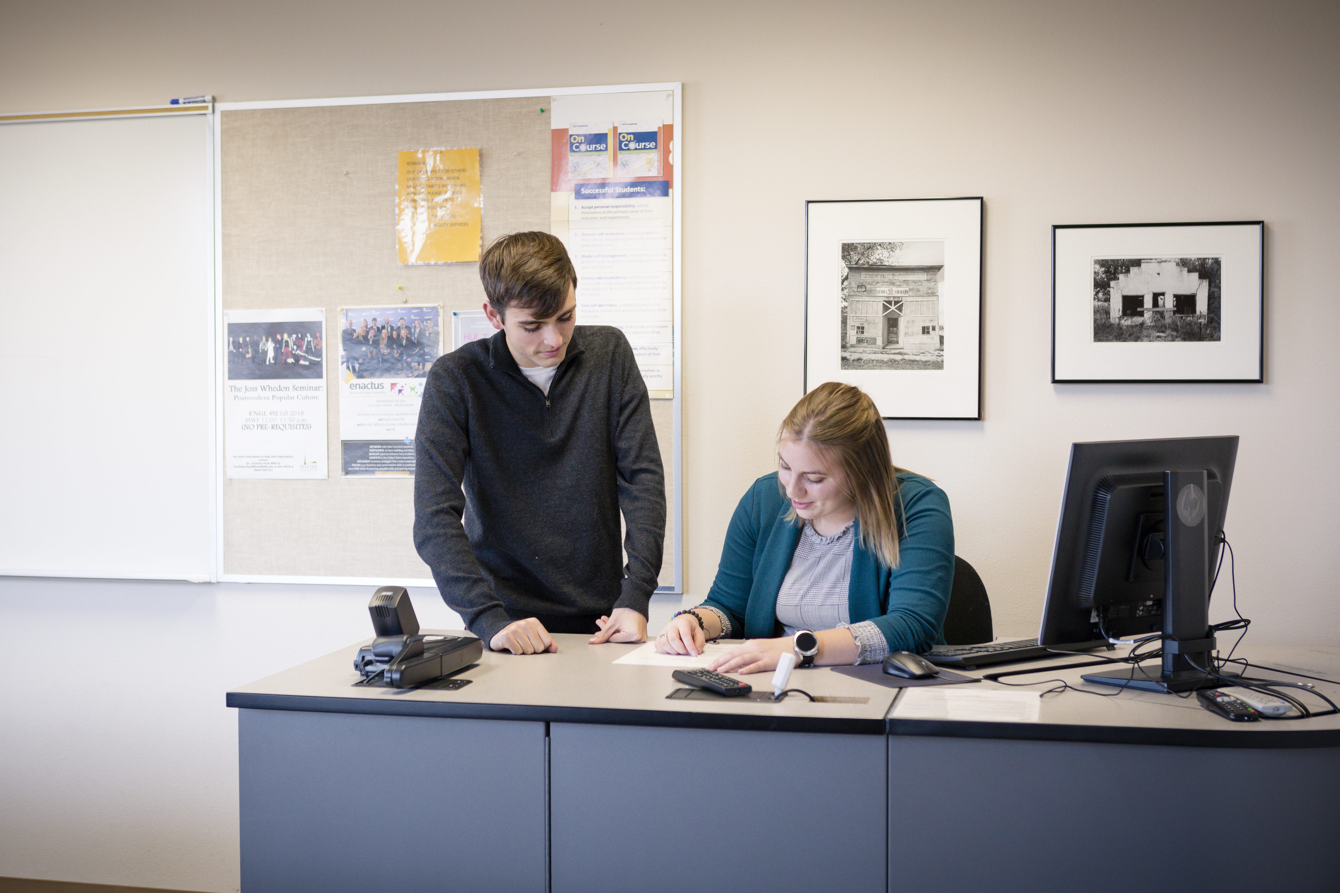 Two Leadership students sit in a classroom together.