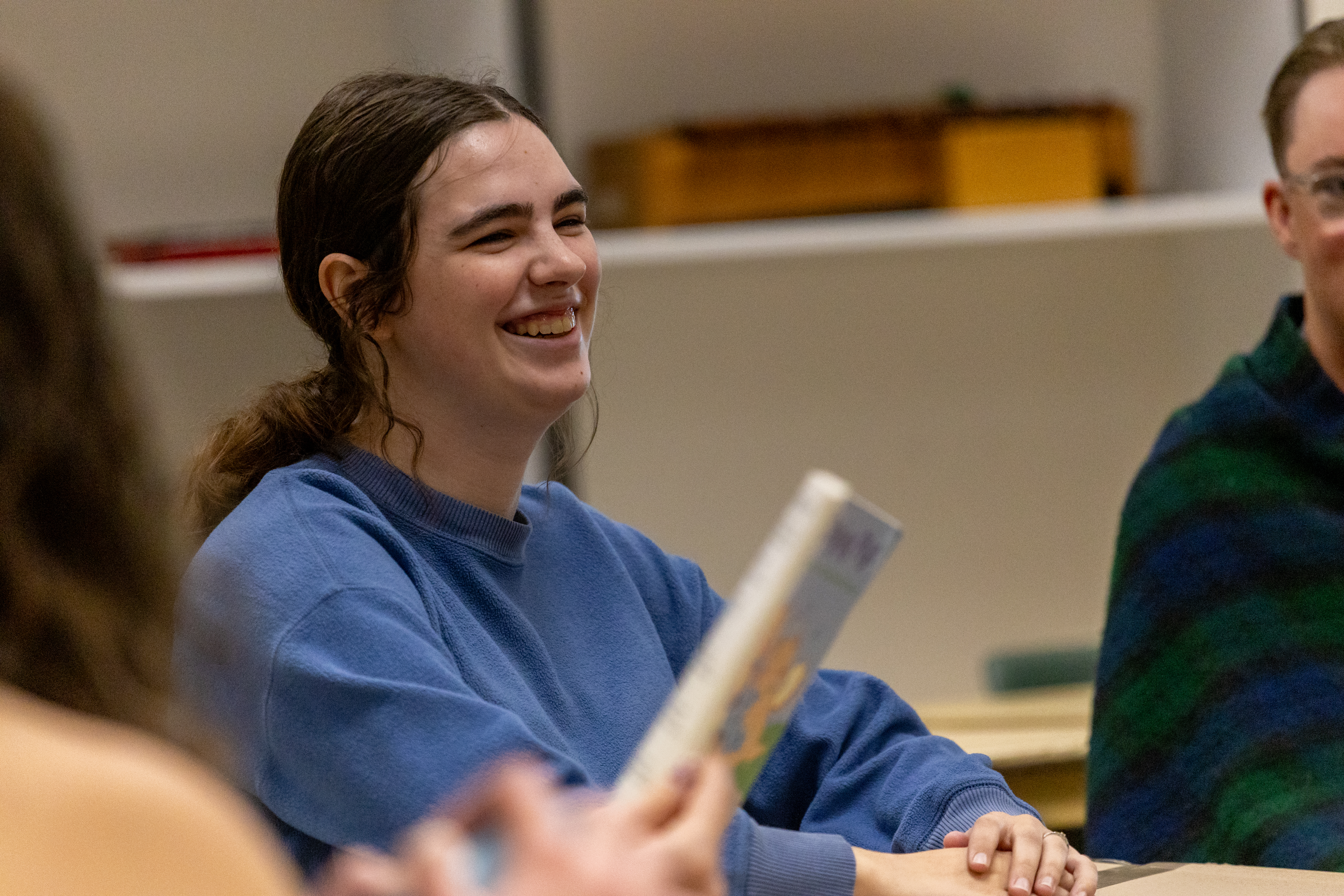 A music education student smiles in class,