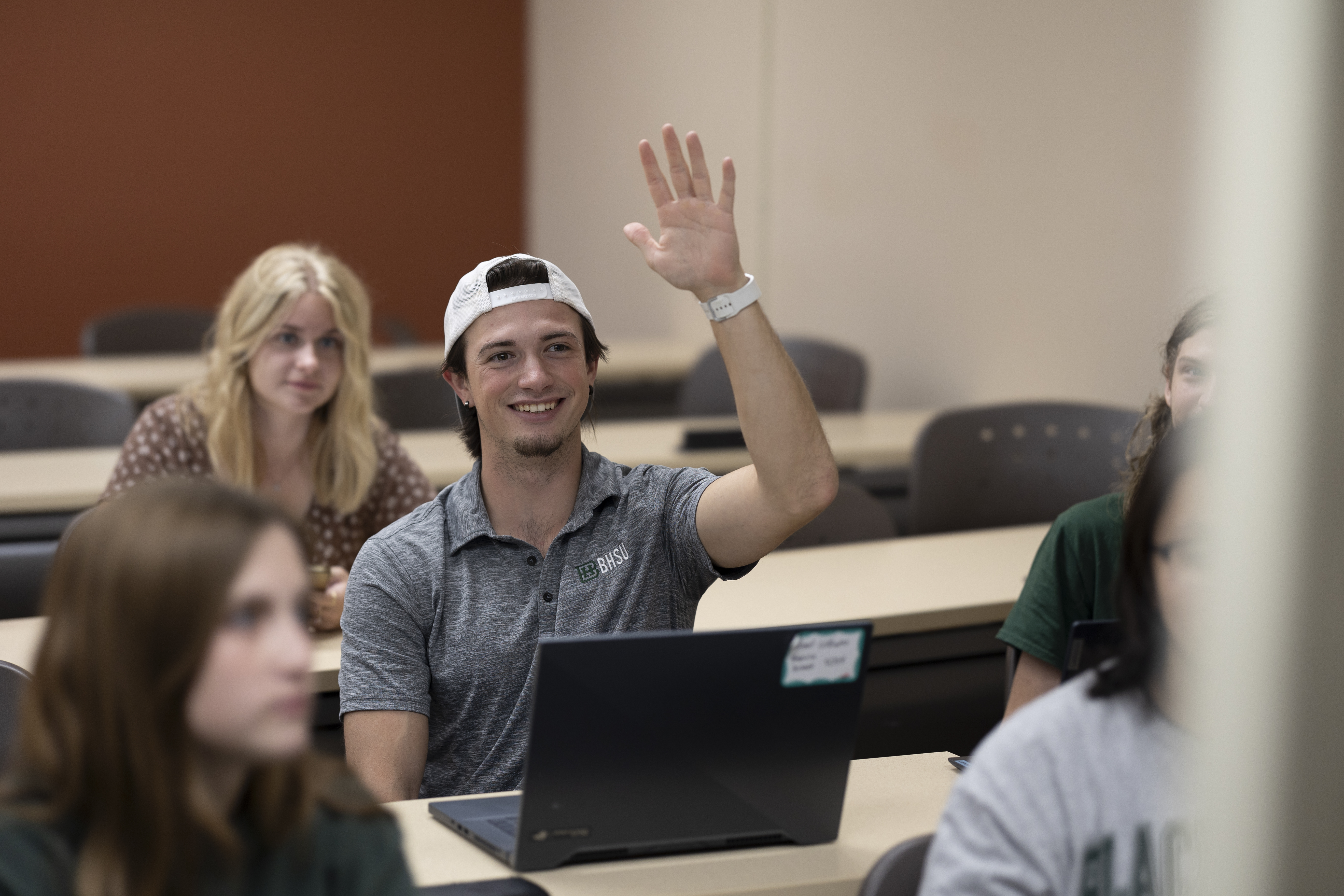 A BHSU student raises his hand in class.