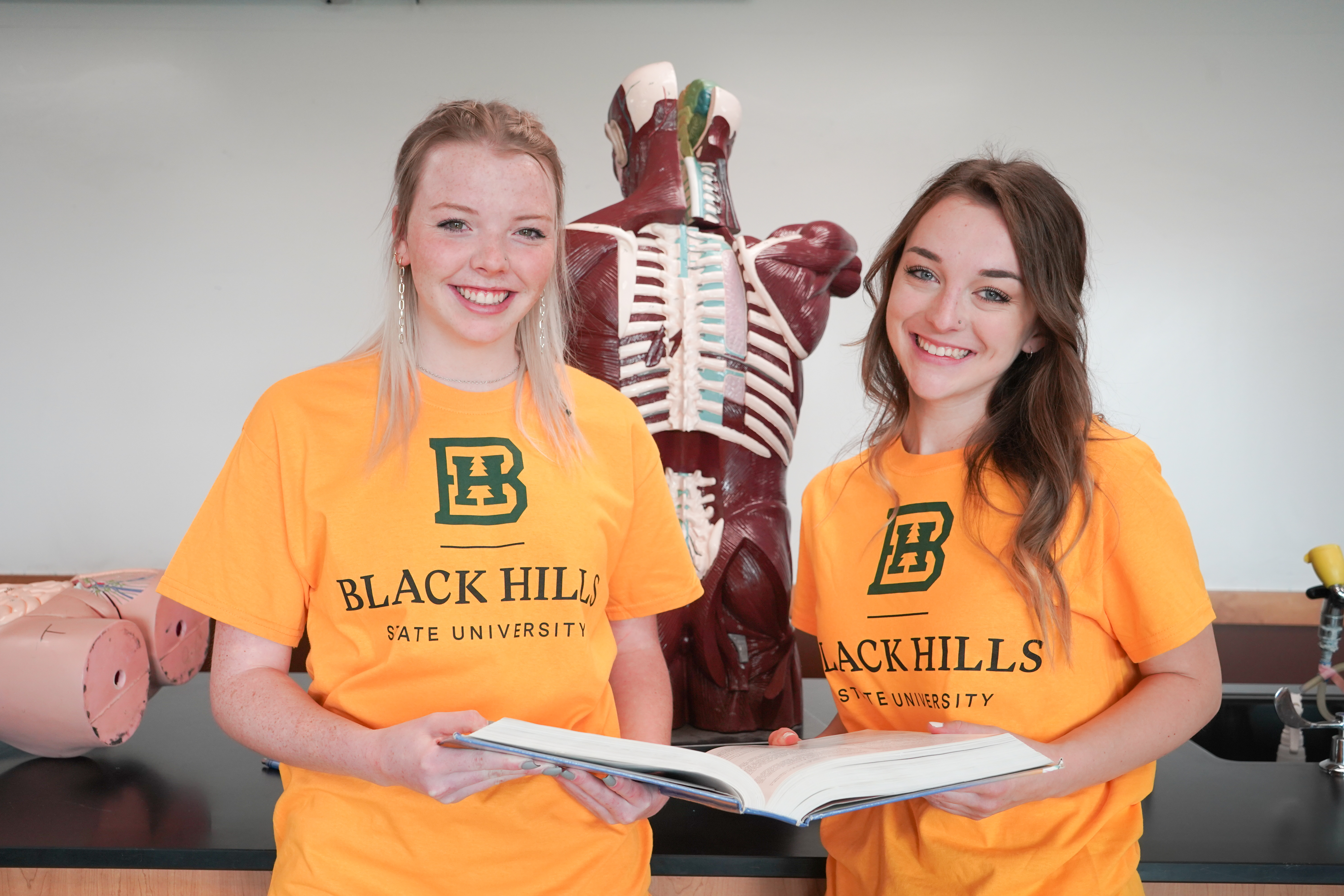 Two pre-nursing students pose for a photo.