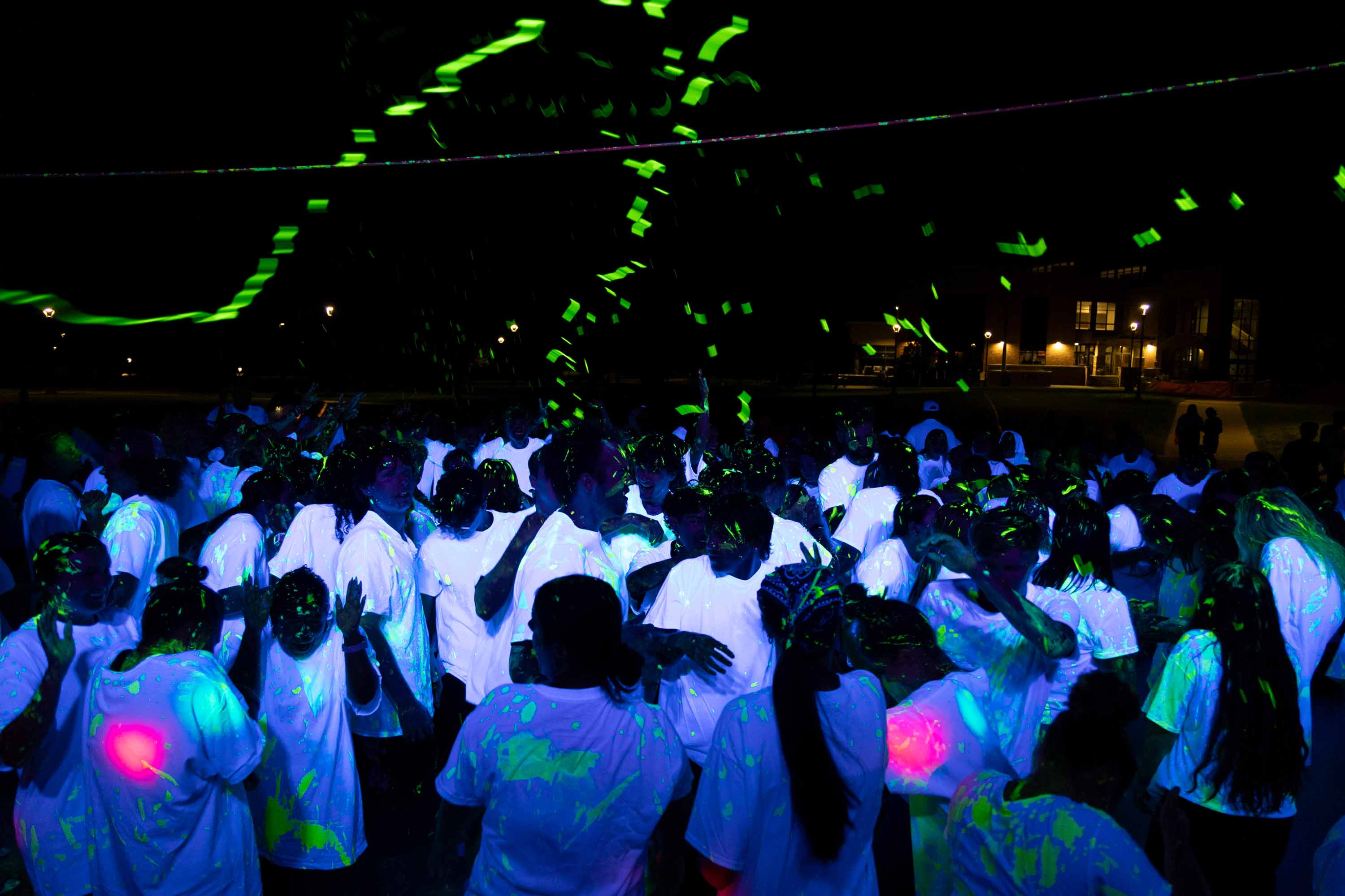 Many students in a crowd dancing at BHSU glow dance