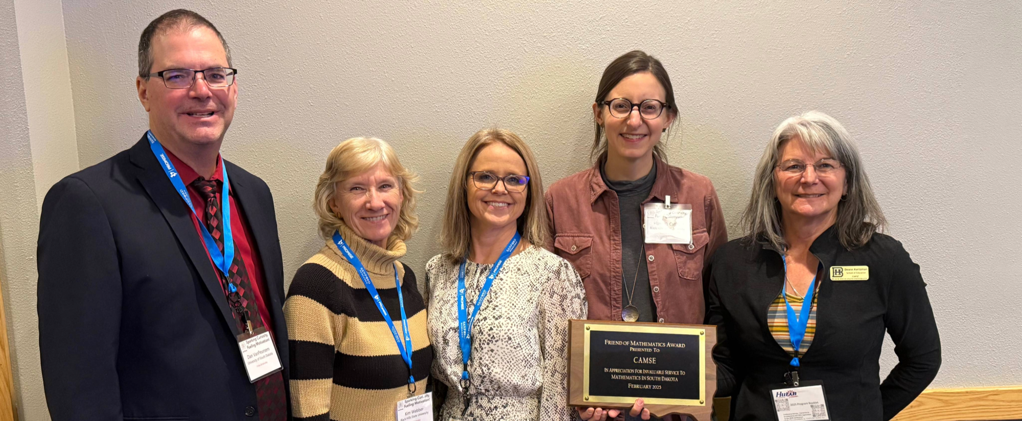 Photo of 5 CAMSE Representatives holding a plaque