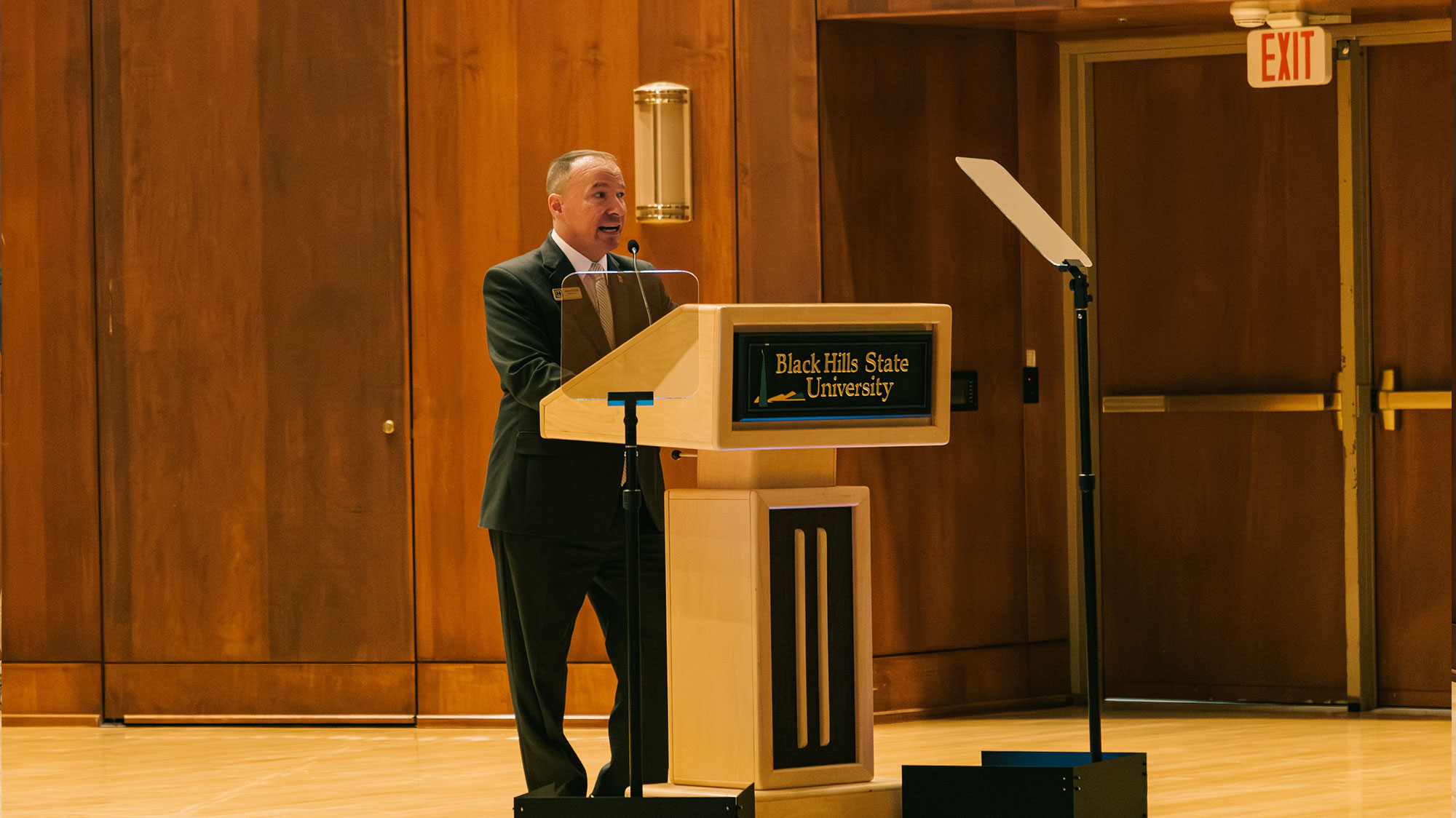 BHSU President Elliott standing at a podium in Meier Hall to deliver the annual State of the University address.